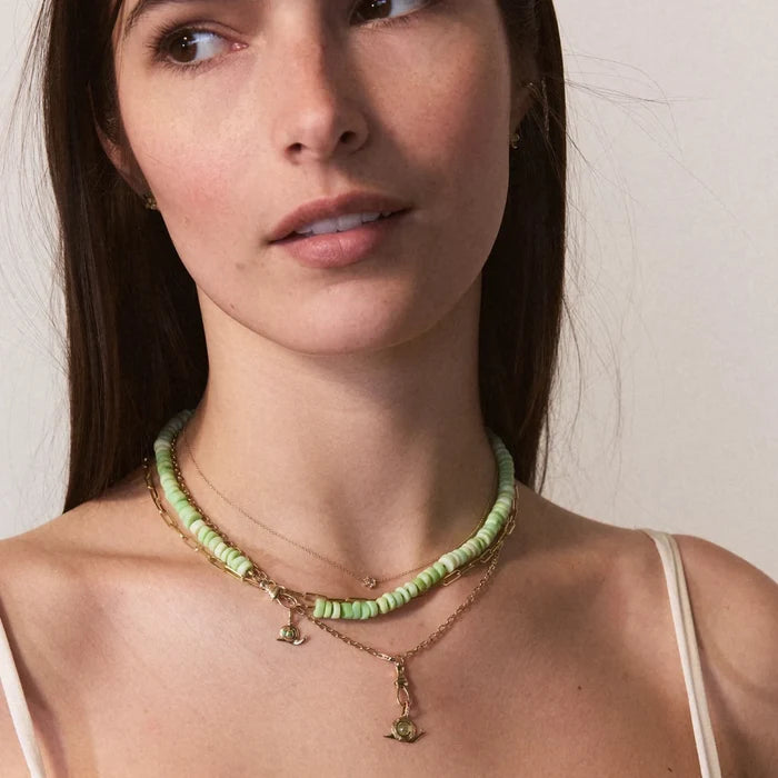 Garden Keeper Snail Charm in 10k yellow gold with peridot, shown worn on hand 2
