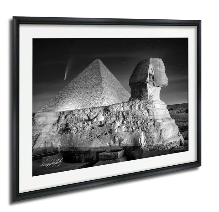 The image is a black and white photograph of the Great Pyramid of Giza and the Sphinx, with a shooting star visible in the sky.