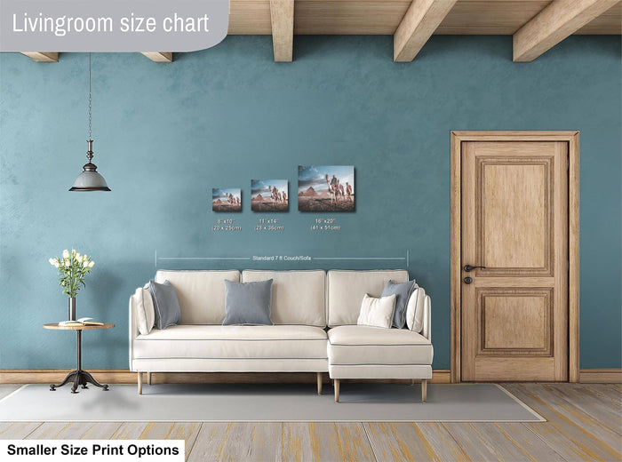 a living room with a white sofa, a wooden door, and a hanging light fixture. There are three framed artworks displayed on the wall, each with different sizes and dimensions. The living room appears to be designed for a smaller space, as indicated by the "Smaller Size Print Options" text at the bottom of the image.