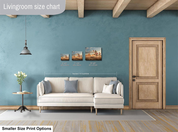 a living room with a white sofa, a wooden door, and a hanging light fixture. There are three framed artworks displayed on the wall, each with different sizes and dimensions. The living room appears to be designed for a smaller space, as indicated by the "Smaller Size Print Options" text at the bottom of the image.