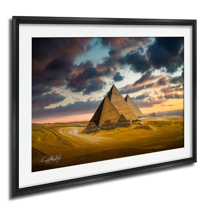 the iconic pyramids of Giza in Egypt, with a dramatic sky in the background featuring clouds and a colorful sunset.