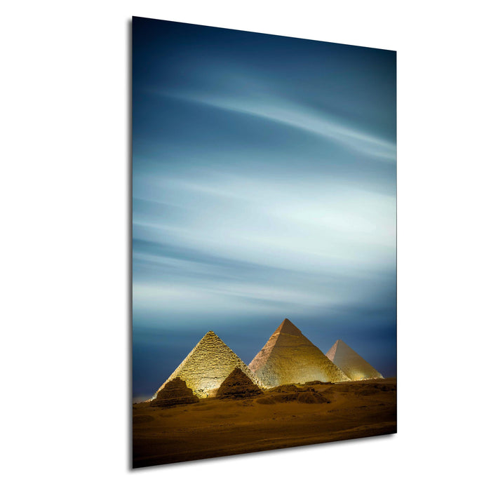 the three pyramids of Giza in Egypt, with the sky and clouds in the background.