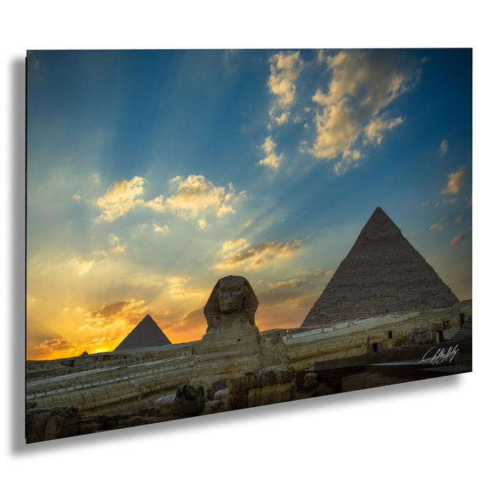 the iconic pyramids of Giza in Egypt, with the Great Sphinx in the foreground and a stunning sunset sky in the background.