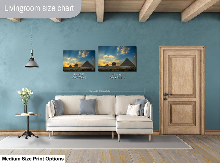 a living room with a white sofa and a wooden door. Above the sofa, there is a livingroom size chart that provides the dimensions of the artwork displayed on the wall.