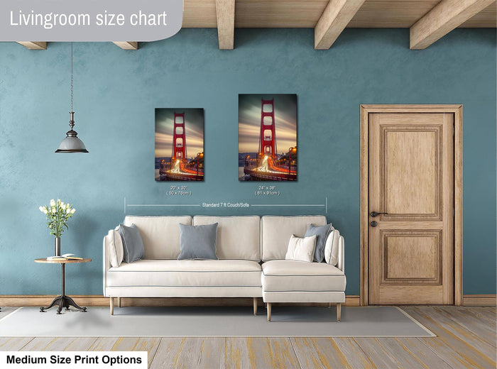 a living room with a white sofa, a wooden door, and a framed picture of the Golden Gate Bridge hanging on the wall.