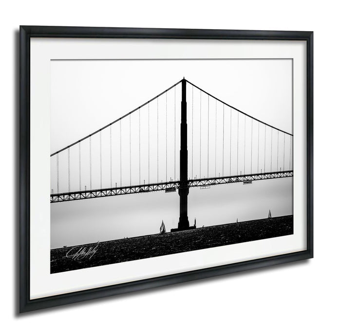 A black and white photograph of the Golden Gate Bridge, a suspension bridge with a distinctive tower and cables, spanning across a body of water.