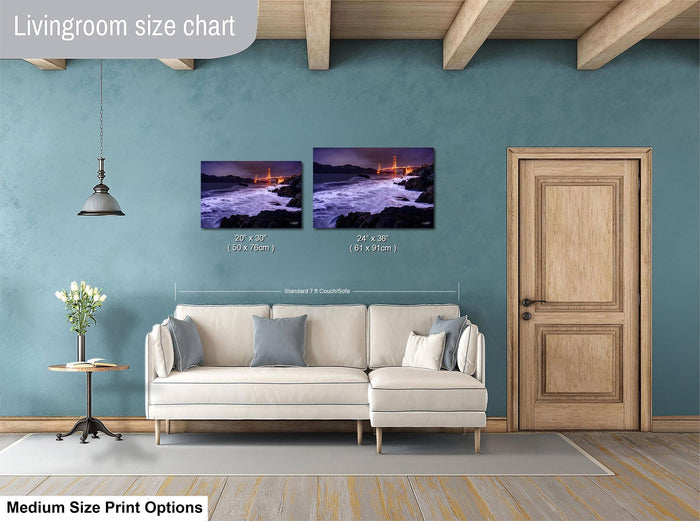 a living room with a white sofa, a wooden door, and a painting of a coastal scene hanging on the wall.