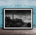 A black and white photograph of the Golden Gate Bridge in San Francisco, California, with a cloudy sky in the background.