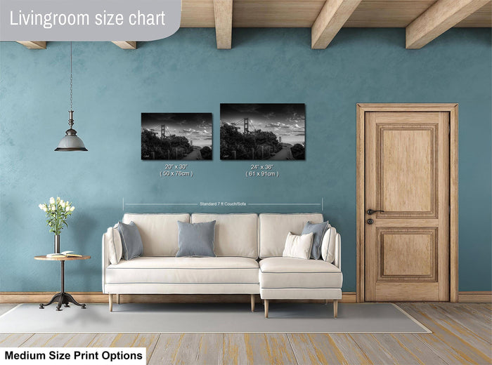 a living room with a white sofa, a wooden door, and a painting on the wall. The painting is of a landscape with a bridge and trees. The living room appears to be well-lit and has a modern design.