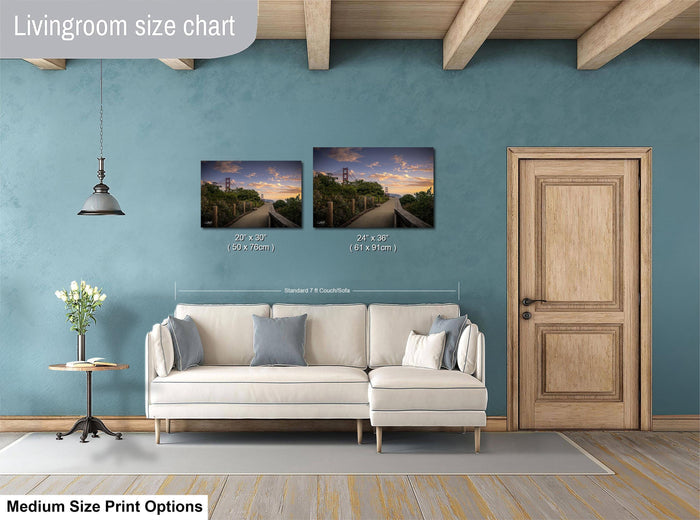 a living room with a white sofa, a wooden door, and a painting of a scenic landscape on the wall.