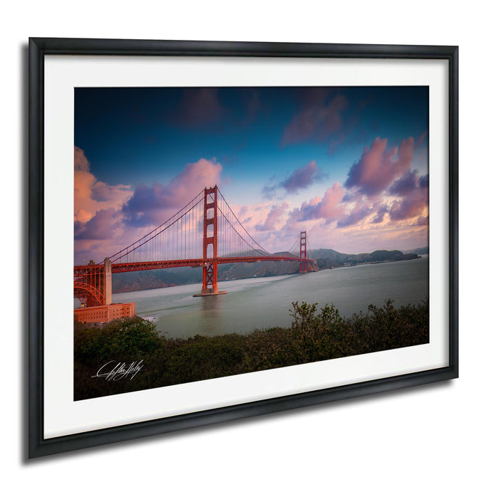 a beautiful sunset over the Golden Gate Bridge, with the iconic red suspension bridge spanning the San Francisco Bay.