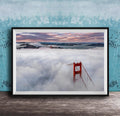 A framed photograph depicting the Golden Gate Bridge in foggy conditions, with the bridge's iconic red towers visible through the mist.