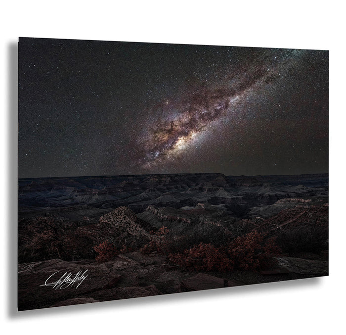 a breathtaking view of the night sky, showcasing a stunning galaxy with vibrant colors and intricate patterns. The vast expanse of space is filled with countless stars, creating a mesmerizing spectacle. The landscape below is rugged and rocky, adding a sense of depth and scale to the scene. The image is a captivating representation of the wonders of the universe, inviting the viewer to marvel at the beauty and complexity of the cosmos.