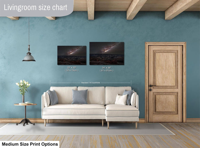 a living room with a white sofa, a wooden door, and a painting of a galaxy hanging on the wall. The living room appears to be modern and well-decorated.