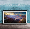 A framed photograph of the Grand Canyon, showcasing the vast and breathtaking landscape with its dramatic rock formations and vibrant colors at sunset.