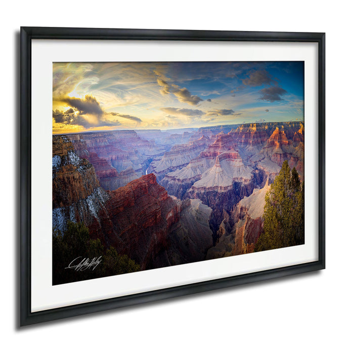 The image is a framed photograph of the Grand Canyon, showcasing the vast and breathtaking landscape with its dramatic rock formations and vibrant colors.