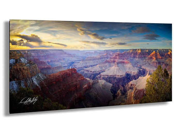 a breathtaking view of the Grand Canyon, with its vast, rugged landscape stretching out beneath a dramatic sky filled with clouds and vibrant colors.