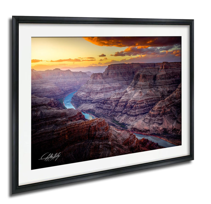 a breathtaking view of the Grand Canyon, with its vast, rugged landscape stretching out beneath a vibrant sunset sky.