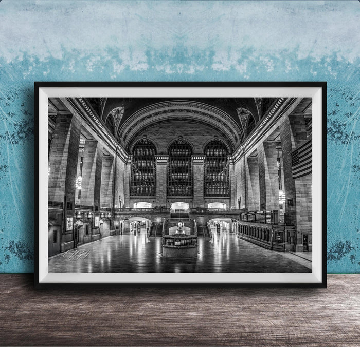 The image is a black and white photograph of a grand, ornate interior space with high ceilings, arched windows, and intricate architectural details.