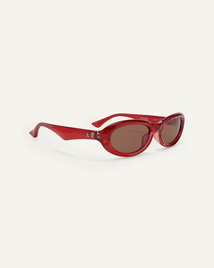 Quarter shot of Bonnie Clyde Groupie sunglasses in red with brown lenses.