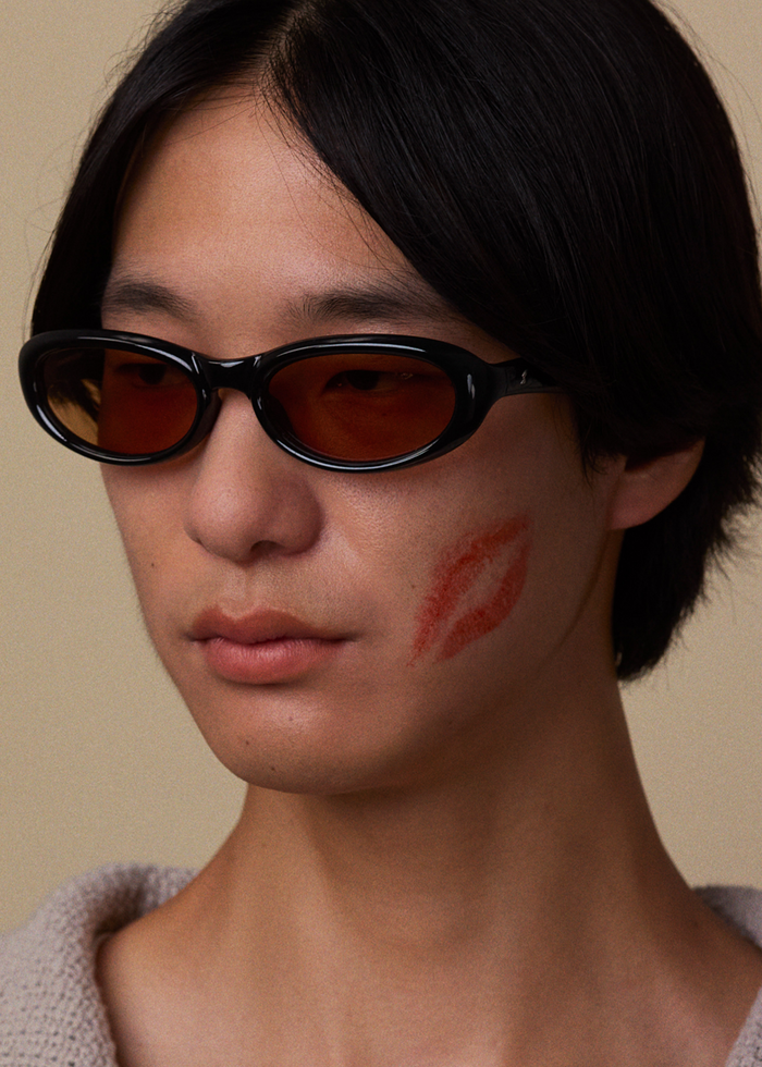 Quarter shot of Bonnie Clyde Groupie sunglasses in black with brown lenses.