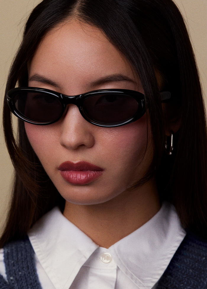 Quarter shot of Bonnie Clyde Groupie sunglasses in black with black lenses.