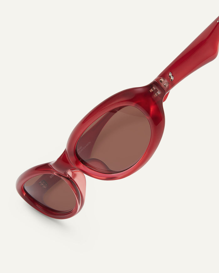 Side shot of Bonnie Clyde Groupie sunglasses in red with brown lenses.