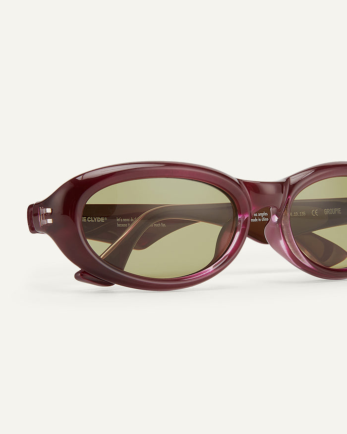 Close-up shot of Bonnie Clyde Groupie sunglasses in wine with olive lenses.