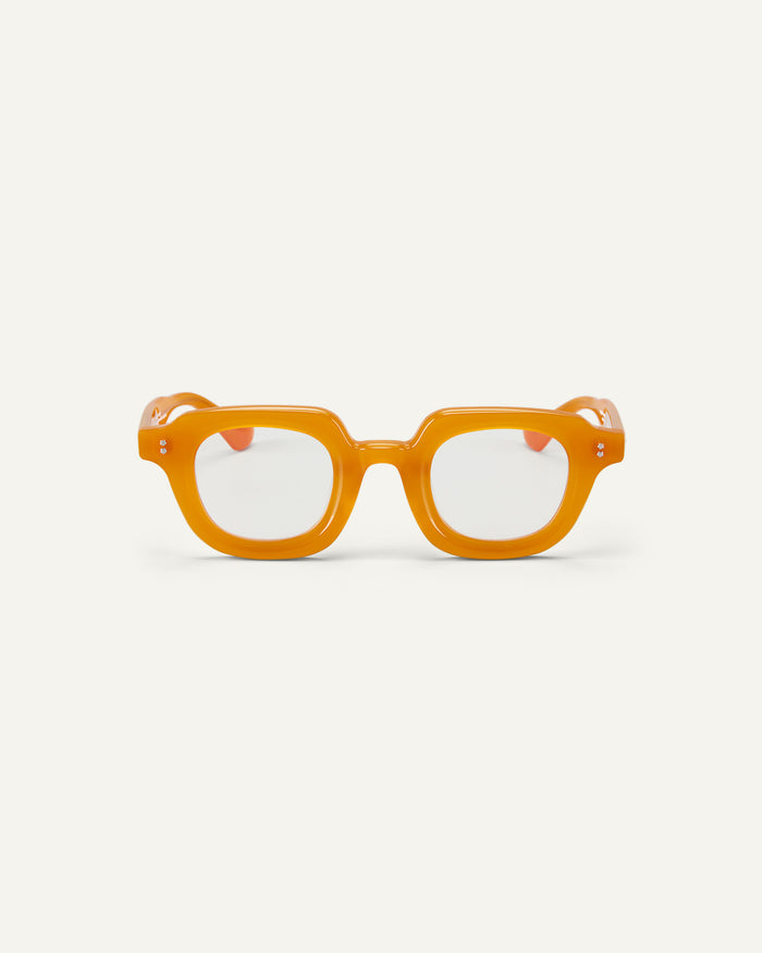 Face shot of Bonnie Clyde Gustave optical frames in orange with clear lenses.