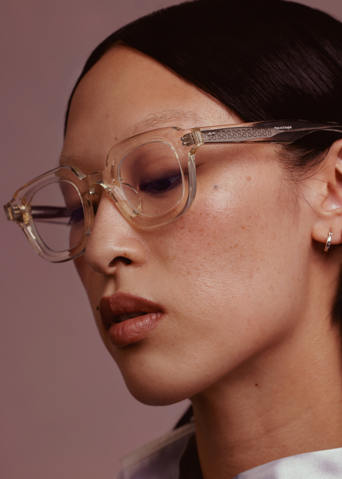Quarter shot of Bonnie Clyde Gustave optical frames in transparent yellow with clear lenses.