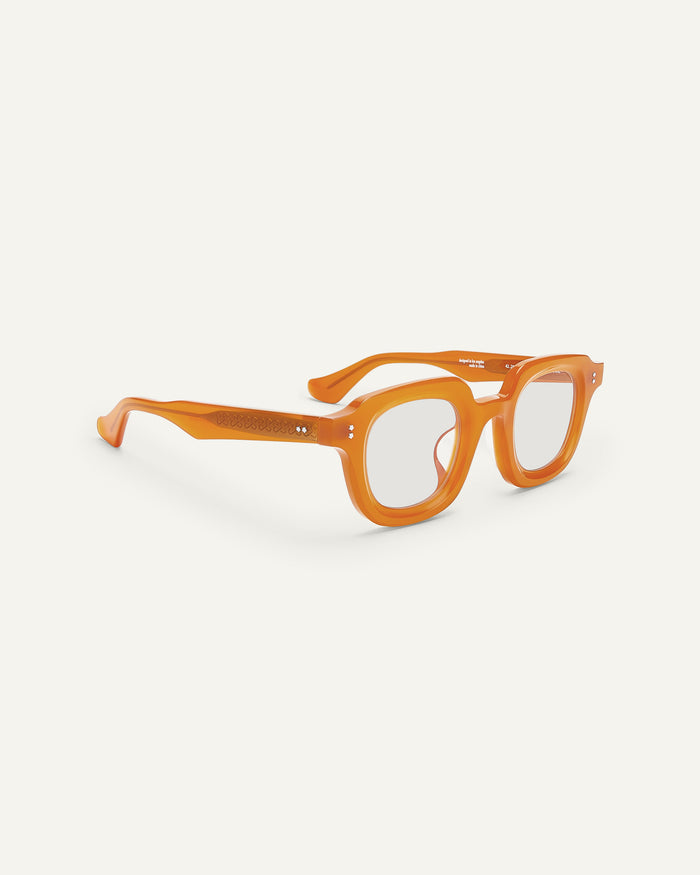 Side shot of Bonnie Clyde Gustave optical frames in orange with clear lenses.