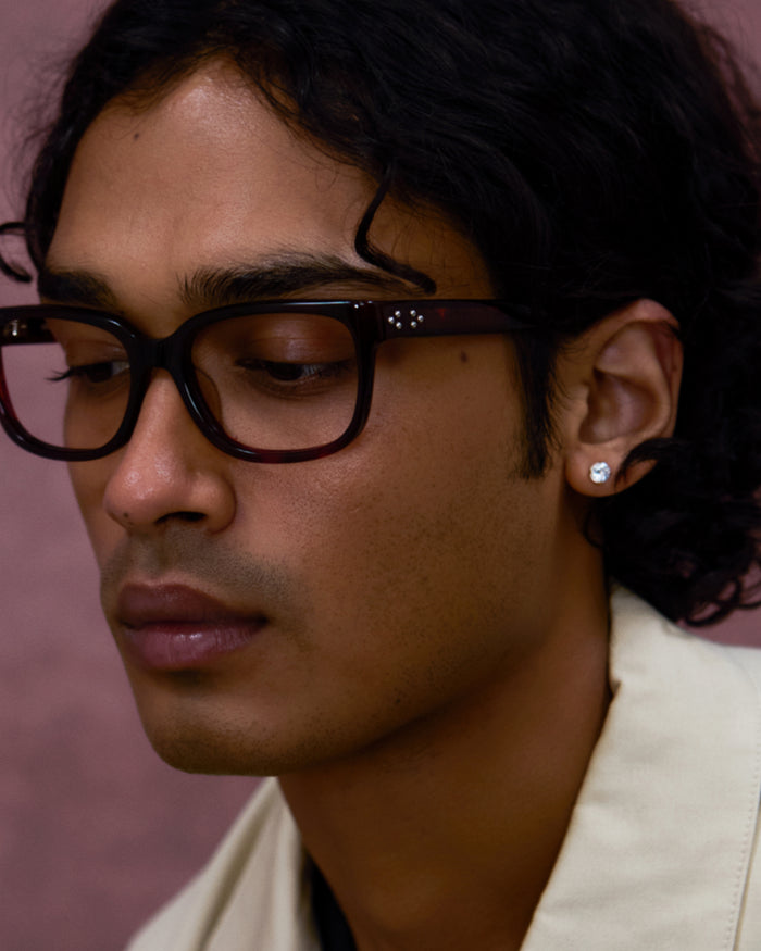 Quarter shot of Bonnie Clyde Guts optical frames in red tortoise with clear lenses.