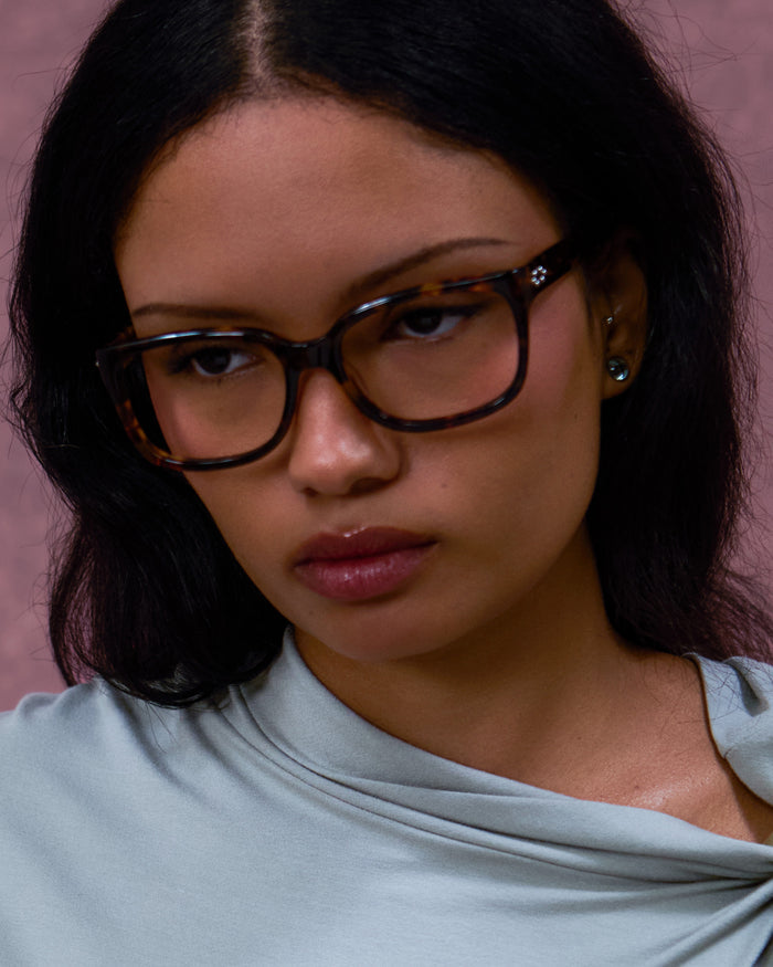 Quarter shot of Bonnie Clyde Guts optical frames in tortoise with clear lenses.