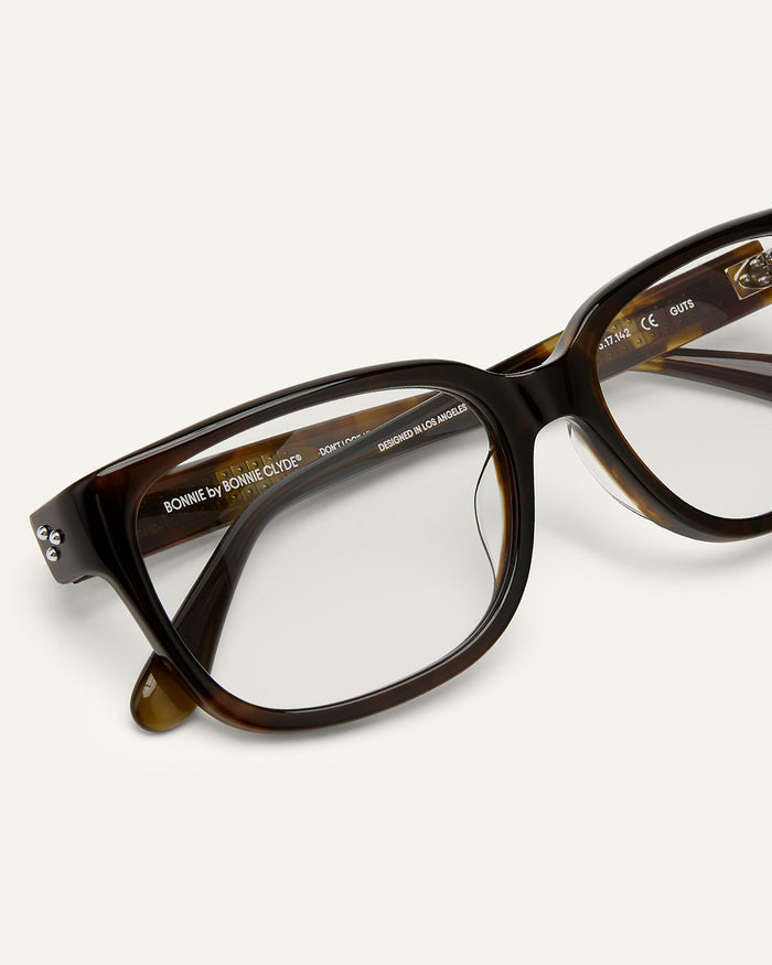 Side shot of Bonnie Clyde Guts optical frames in green tortoise with clear lenses.