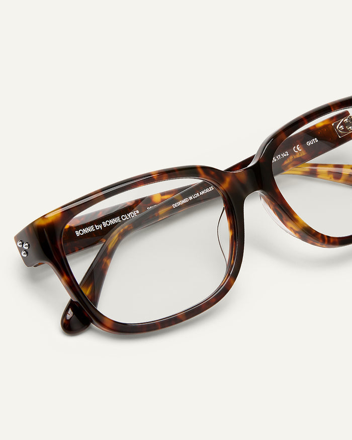 Close-up shot of Bonnie Clyde Guts optical frames in tortoise with clear lenses.