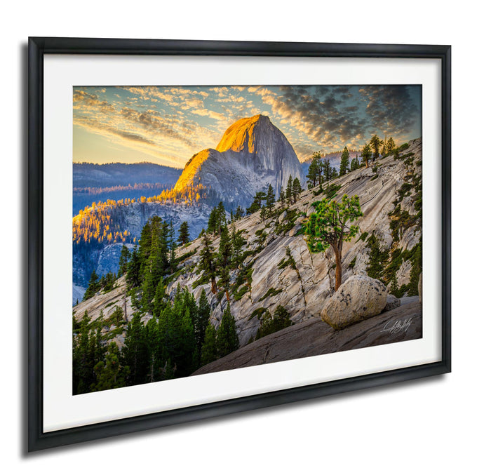 a breathtaking mountain landscape with a large, snow-capped peak in the distance, surrounded by a lush forest and a dramatic sky with vibrant colors.