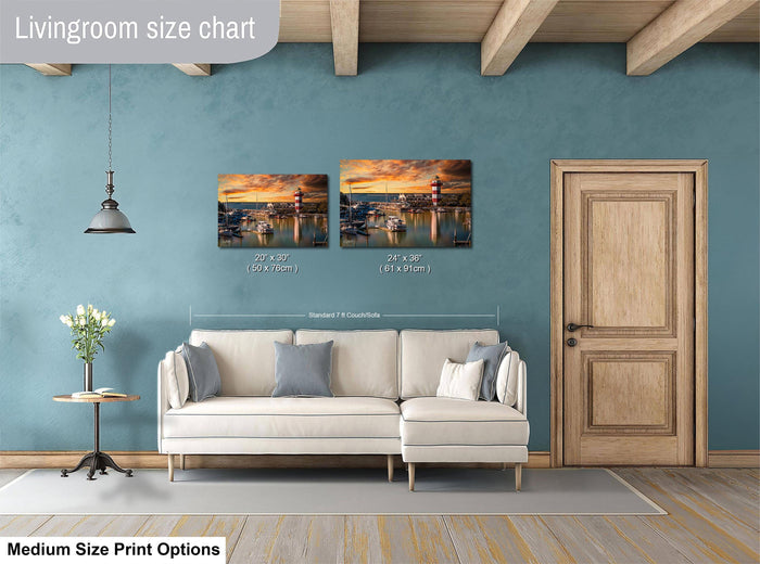 a living room with a white sofa, a wooden door, and a painting of a sunset over a body of water. The painting is hung on the wall above the sofa, and the sofa is positioned in front of the painting.
