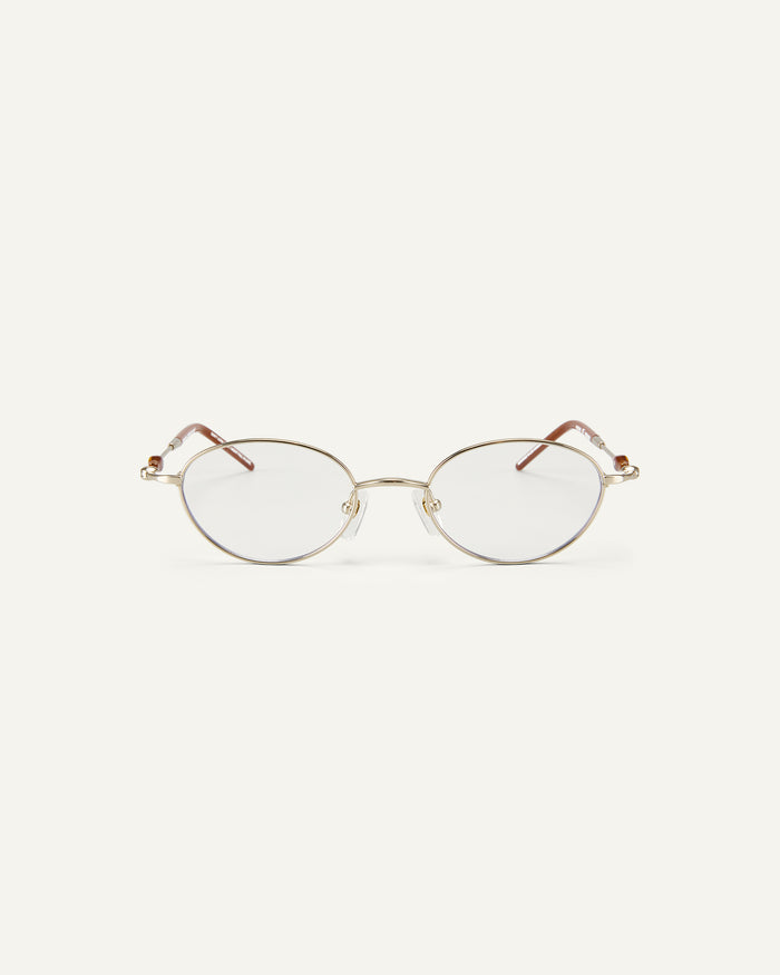 Face shot of Bonnie Clyde Heirloom optical frames in gold and dark brown with clear lenses.