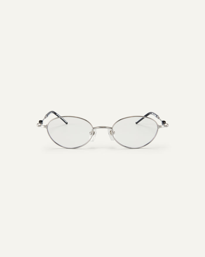Face shot of Bonnie Clyde Heirloom optical frames in silver and black with clear lenses.
