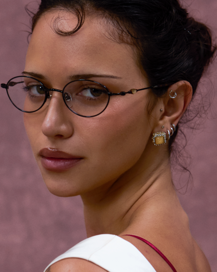 Quarter shot of Bonnie Clyde Heirloom optical frames in black and tortoise with clear lenses.
