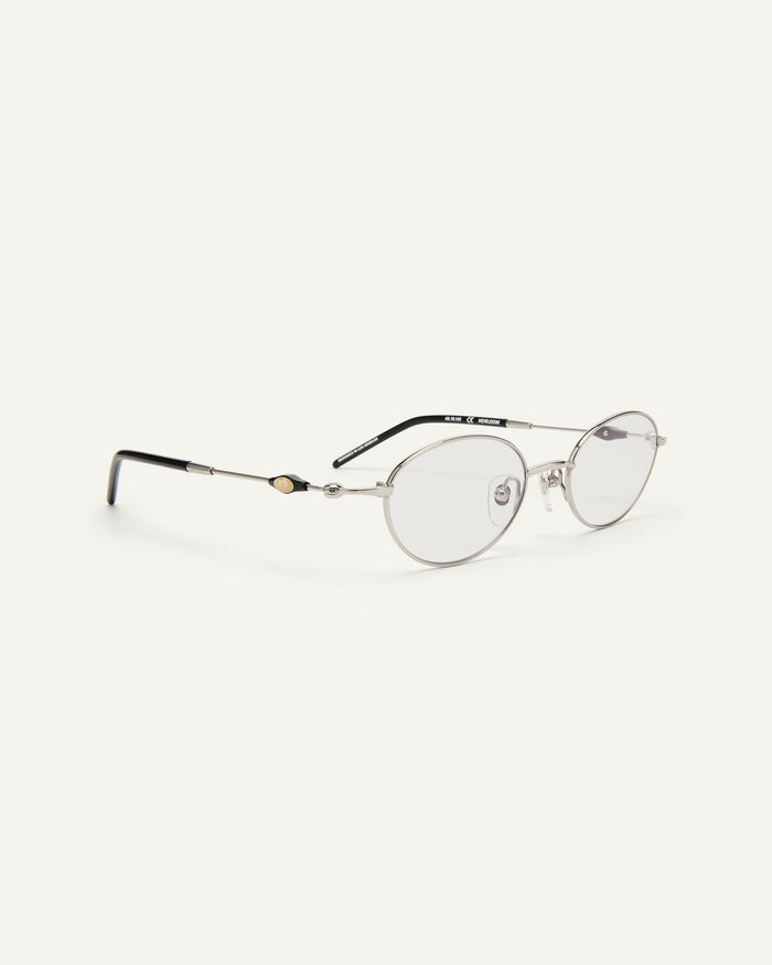 Quarter shot of Bonnie Clyde Heirloom optical frames in silver and black with clear lenses.