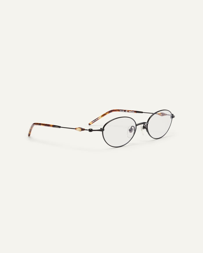 Side shot of Bonnie Clyde Heirloom optical frames in black and tortoise with clear lenses.
