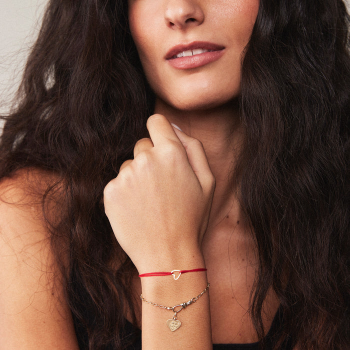 Hold Onto Me Heart Cord Bracelet in 10k yellow gold with red cord, alternate angle detail view