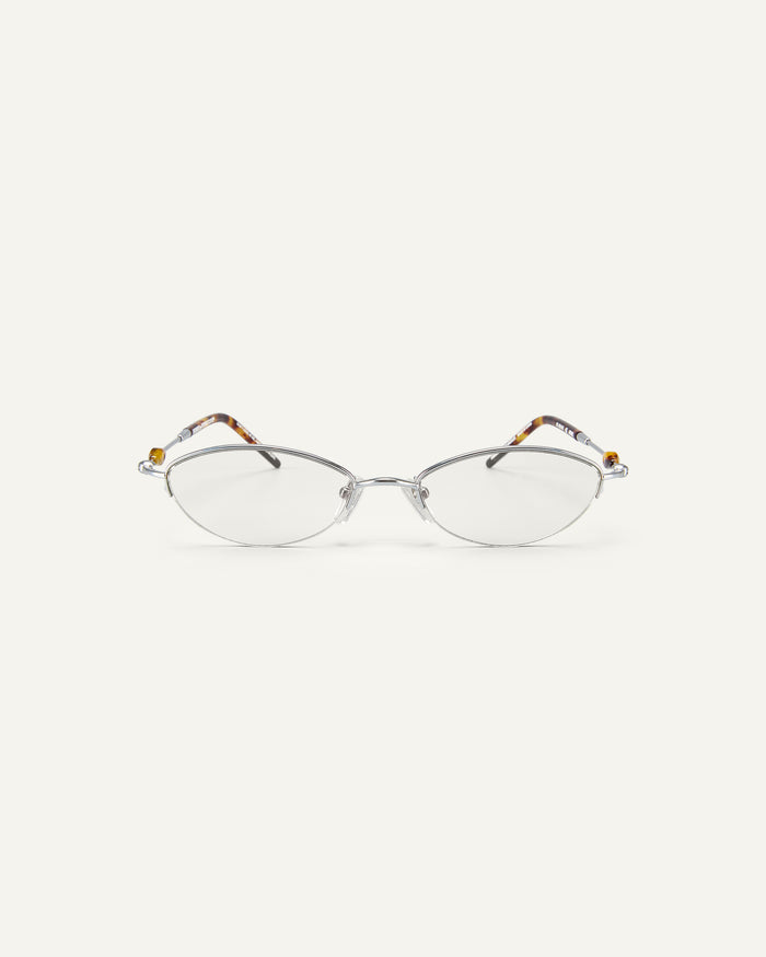 Face shot of Bonnie Clyde Jewel optical frames in silver and tortoise with clear lenses.