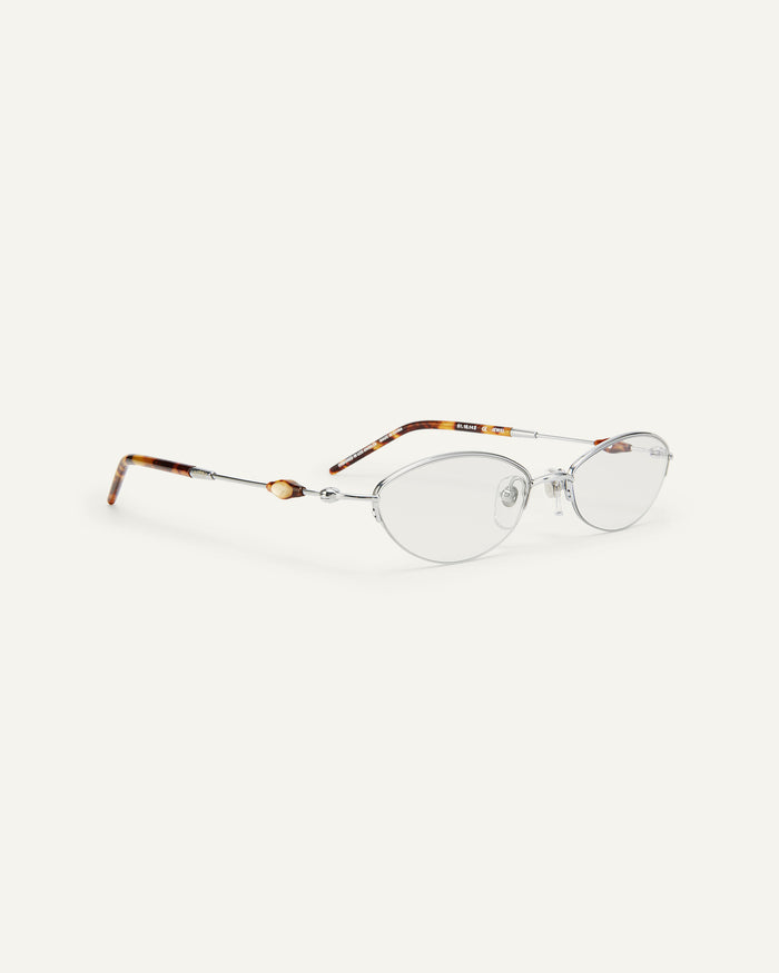 Quarter shot of Bonnie Clyde Jewel optical frames in silver and tortoise with clear lenses.