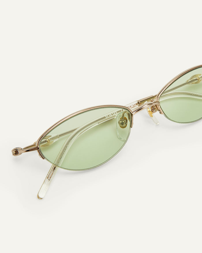 Side shot of Bonnie Clyde Jewel sunglasses in gold with green lenses.