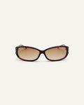 Face shot of Bonnie Clyde Joans sunglasses in red tortoise with brown gradient lenses.