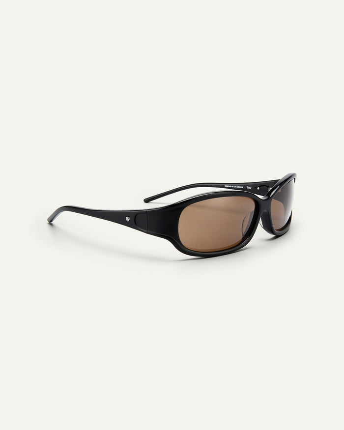 Quarter shot of Bonnie Clyde Joans sunglasses in black with brown lenses.
