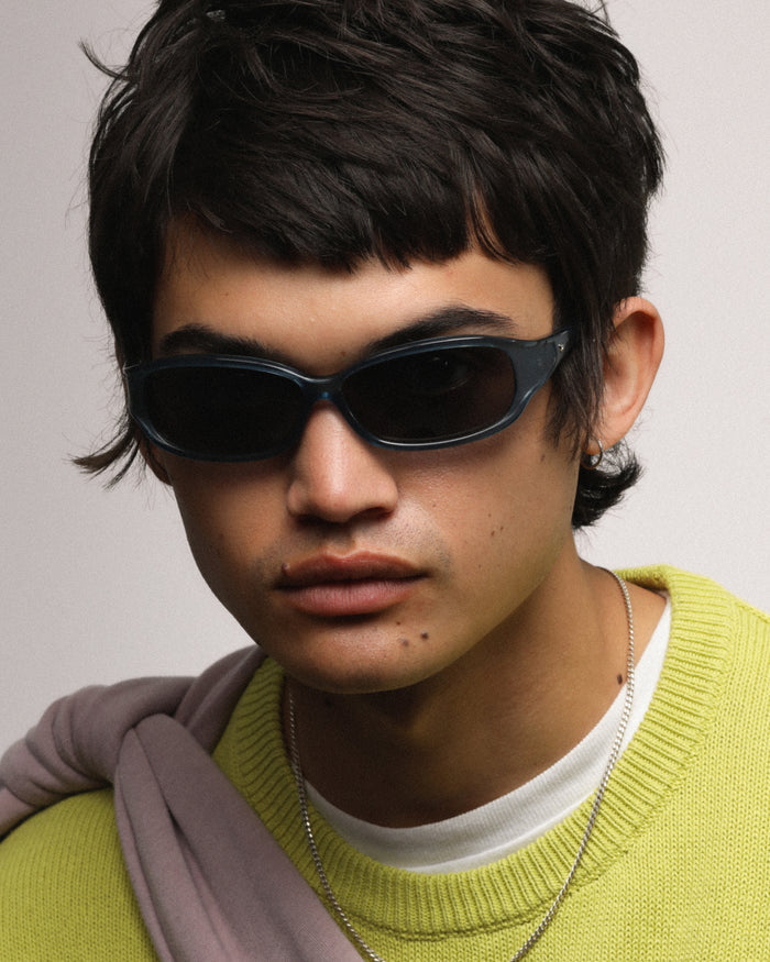 Detail shot of Bonnie Clyde Joans sunglasses in layered blue with black lenses.