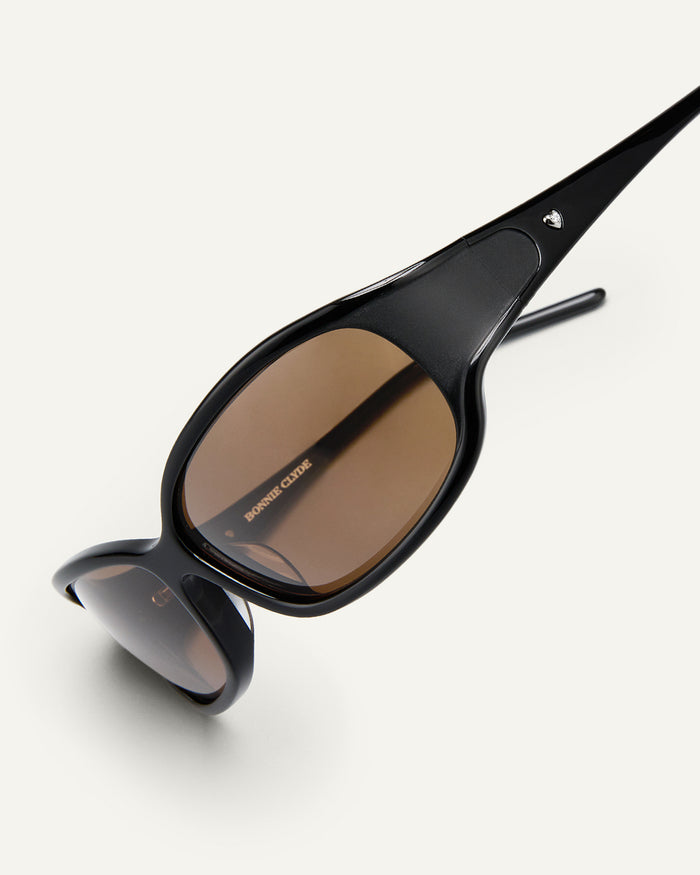 Close-up shot of Bonnie Clyde Joans sunglasses in black with brown lenses.